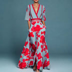 Floral wrap maxi dress with blue base and red floral print, cinched waist belt