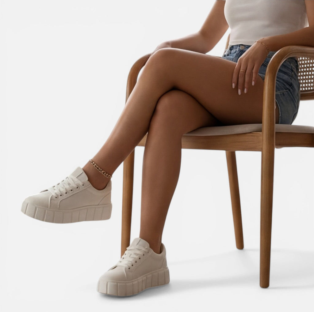 Felorro women's white sneakers with lace-up front and chunky sole, seated legs