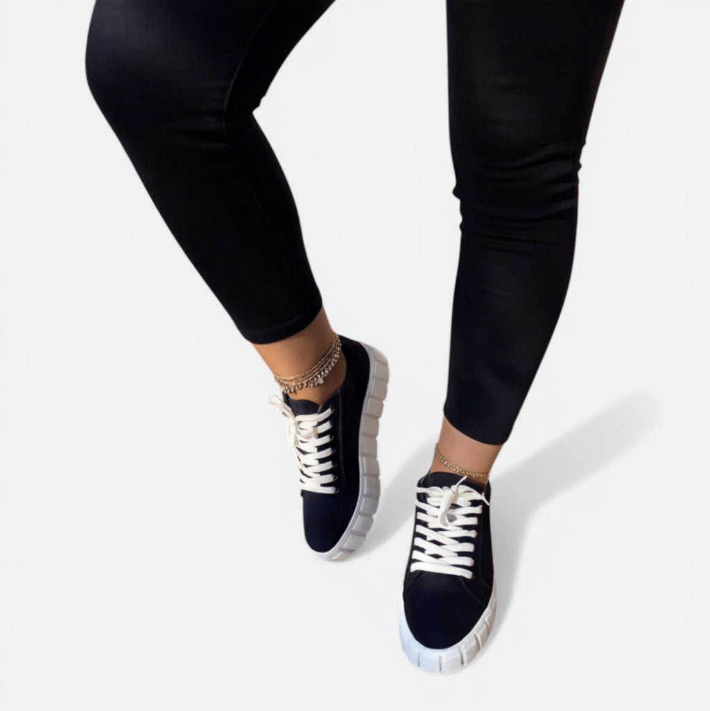 Felorro women's black sneakers with white laces and thick light sole, side view