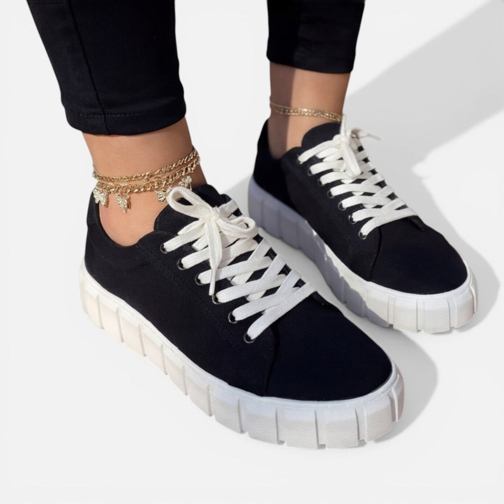 Felorro women's black sneakers with white laces and thick sole, close side view