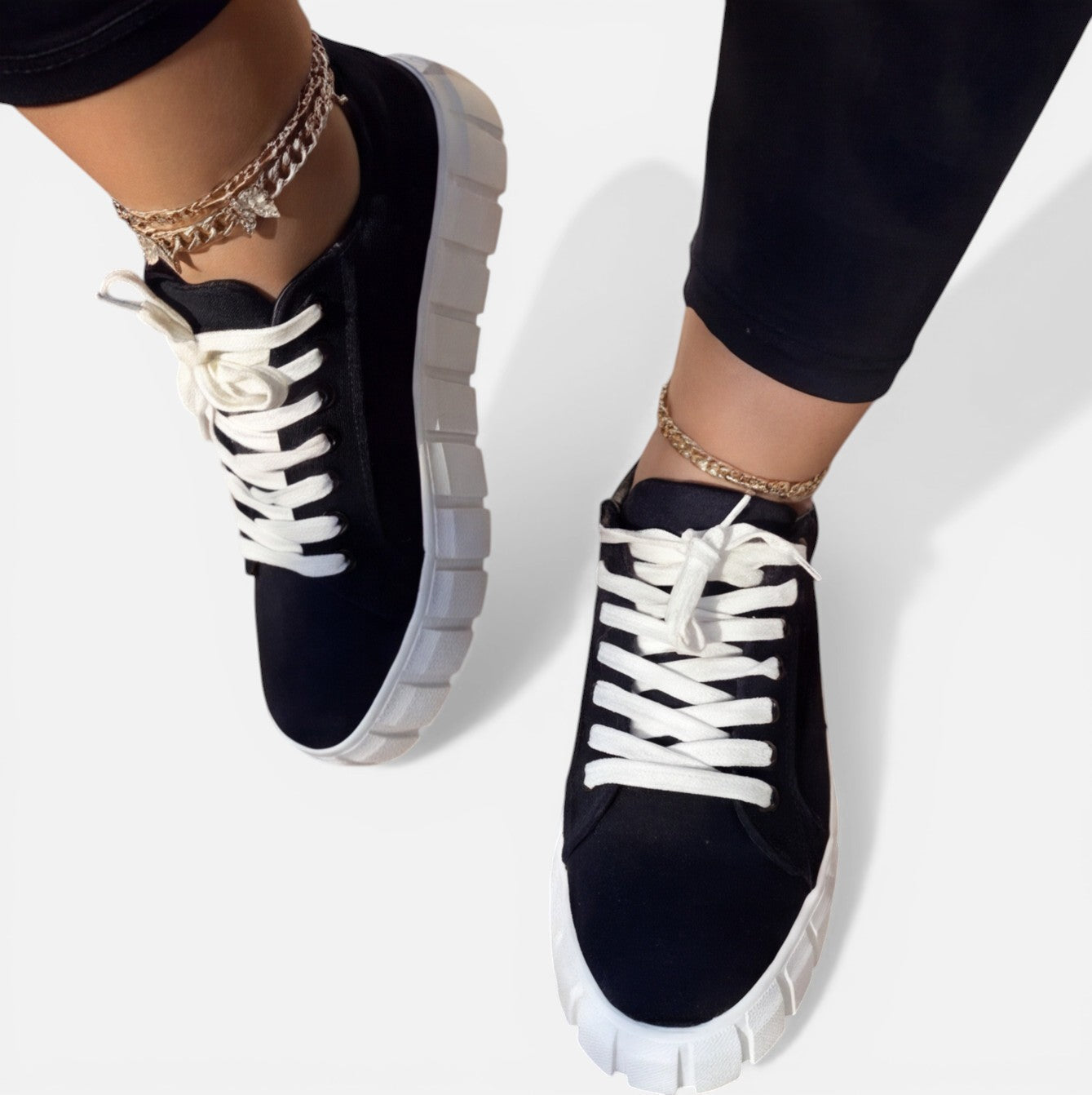 Felorro women's black sneakers with white laces and chunky sole, angled view