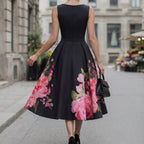 Black midi cocktail dress with sleeveless back and pink rose floral hem panel, A-line silhouette