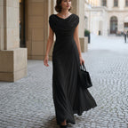 Black maxi dress with draped cowl neckline and side gathers, flowing skirt.