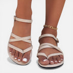 Beige women’s strappy toe-loop flat sandals with ankle strap, open-toe design