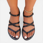 Women’s black strappy toe-loop flat sandals with ankle strap and buckle closure