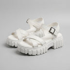 White platform sandals with cross straps and chunky lug sole