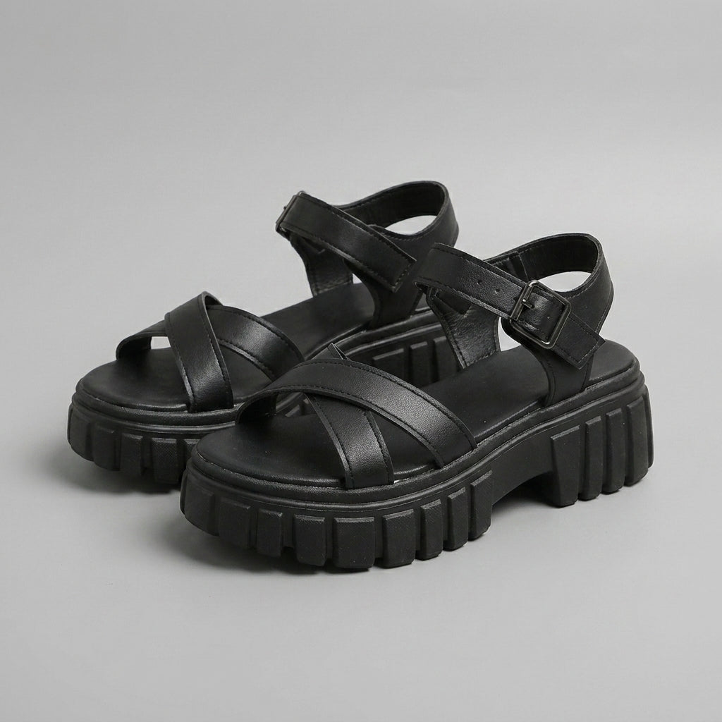 Black platform sandals with crisscross straps and chunky lug sole