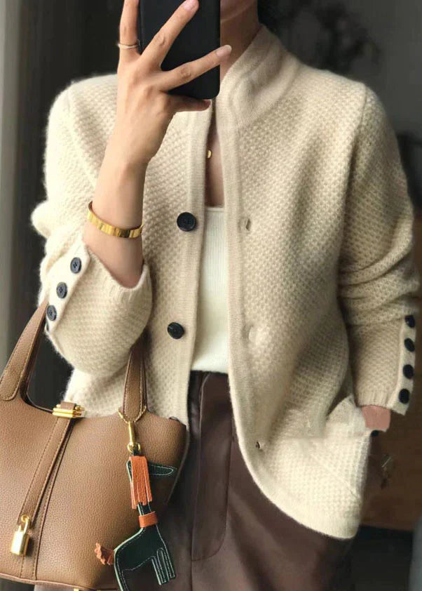 Light beige knitted button-front jacket with stand collar and dark buttons
