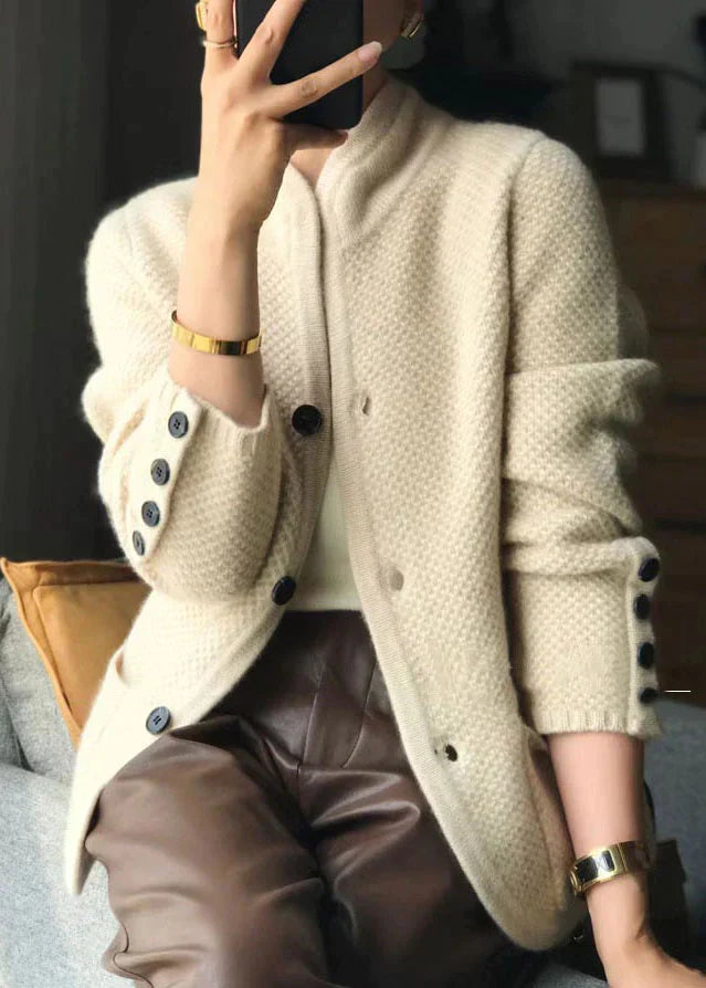 Cream knitted jacket with stand collar, button placket, and textured fabric
