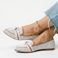 Women’s slip-on loafers in white with bow strap detail and pointed toe