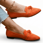 Women’s slip-on loafers in bright orange with bow strap detail and pointed toe