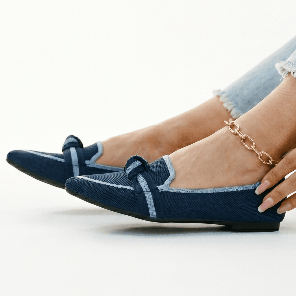 Blue slip-on loafers with bow detail and stitched strap