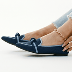 Blue slip-on loafers with bow detail and stitched strap
