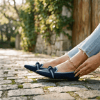 Women’s slip-on loafers in navy blue with bow strap detail and pointed toe