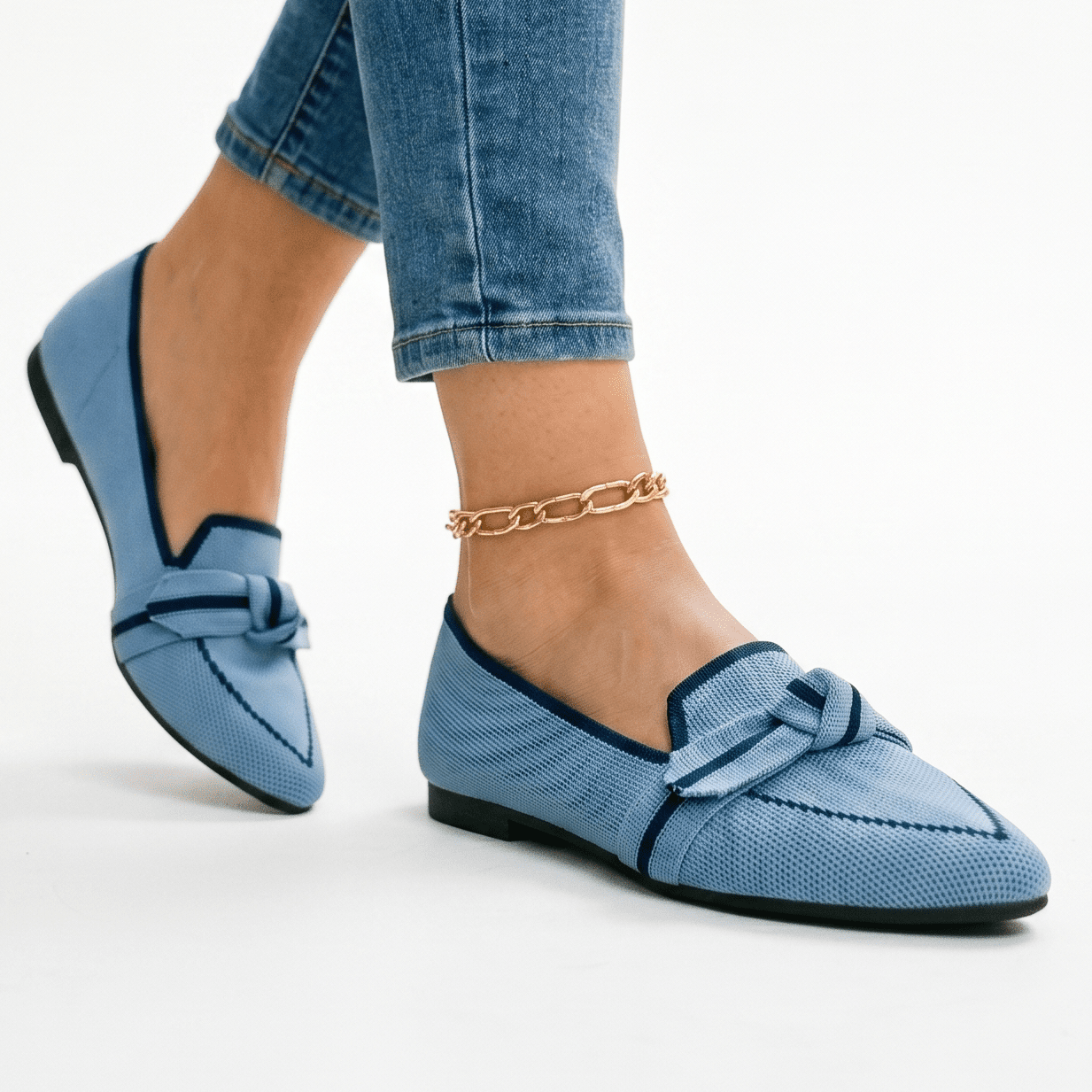 Women’s slip-on loafers in light blue with bow strap detail and pointed toe
