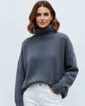 Blue oversized turtleneck knit sweater with ribbed collar, cuffs, and hem