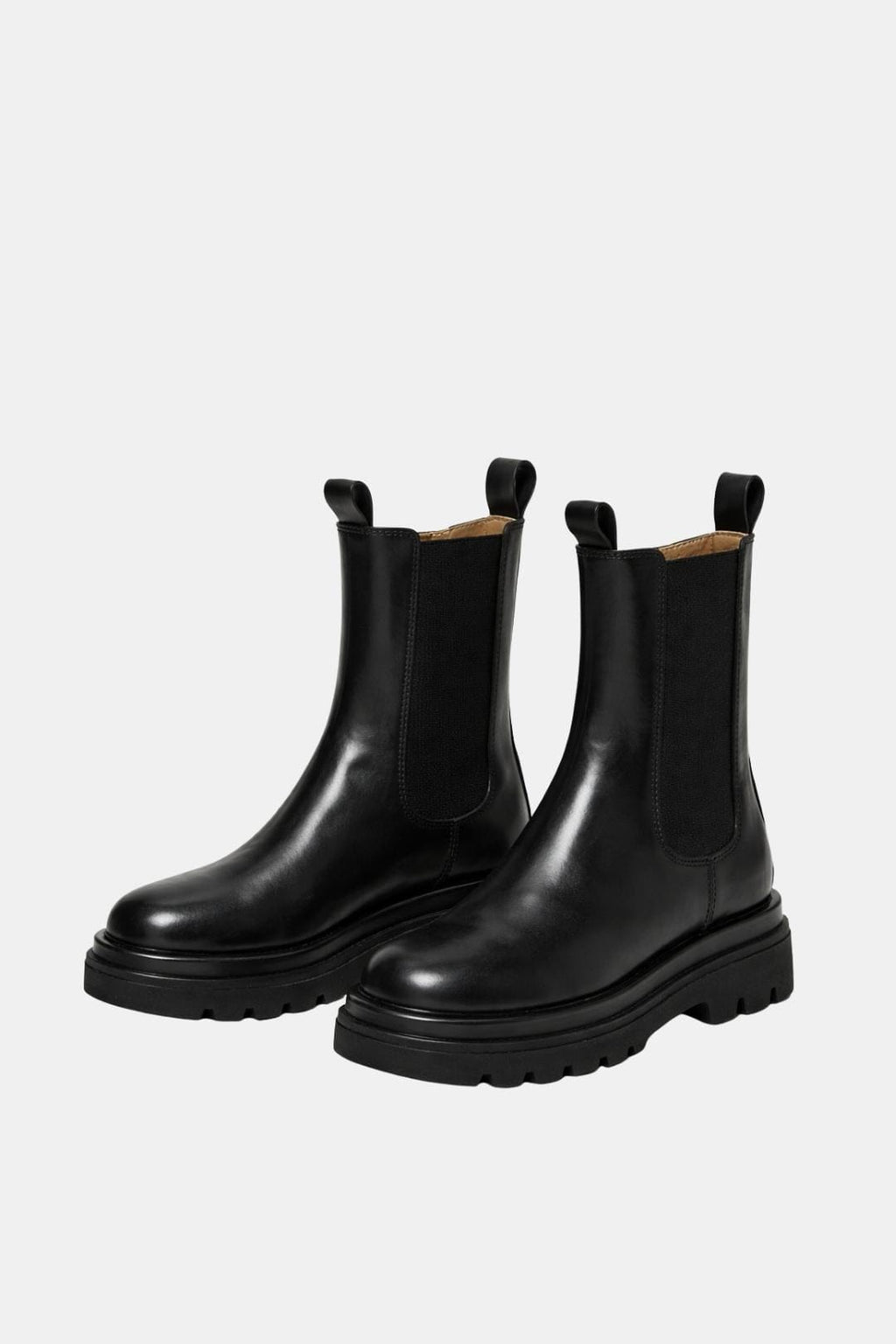 Pair of black platform Chelsea boots with elastic panels and thick tread soles