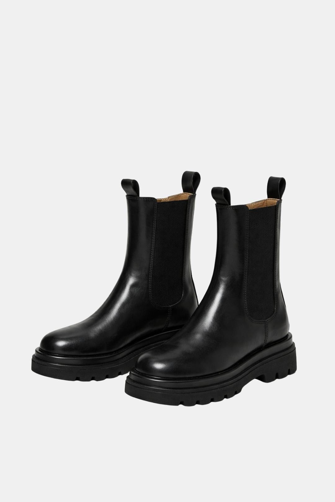 Pair of black platform Chelsea boots with elastic panels and thick tread soles
