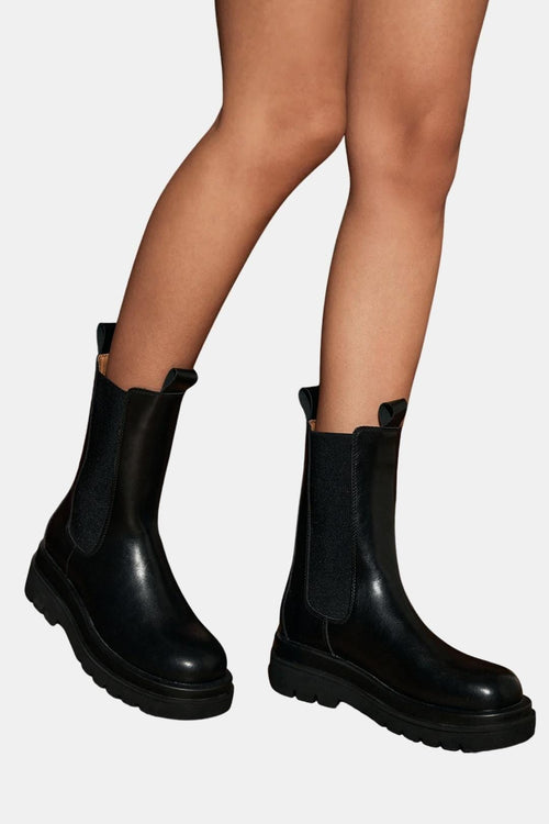 Black chelsea platform boots with chunky tread sole and elastic side panels