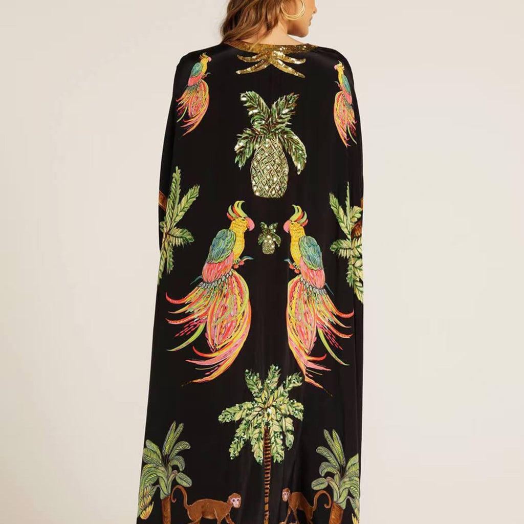 Black kaftan-style dress with tropical bird, pineapple, and palm print, V-neck, long length