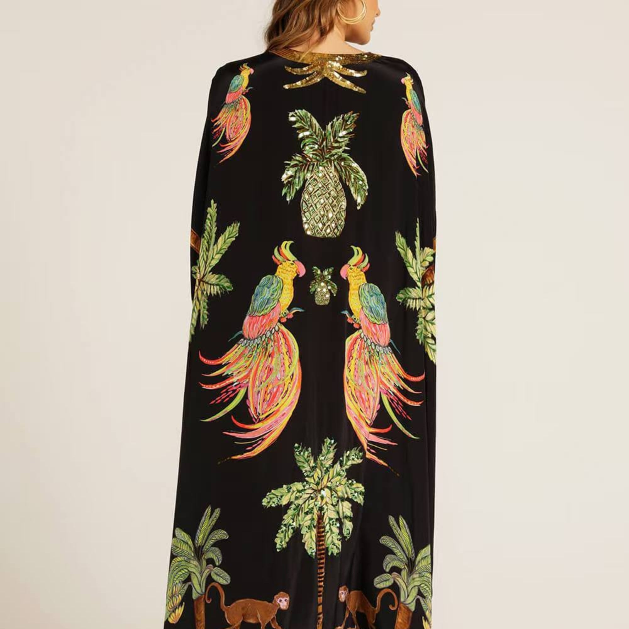 Black kaftan-style dress with tropical bird, pineapple, and palm print, V-neck, long length