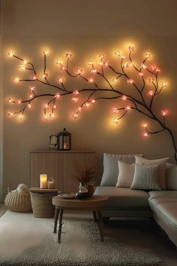 Warm LED cherry blossom vine wall art stretching across the wall with glowing blossoms
