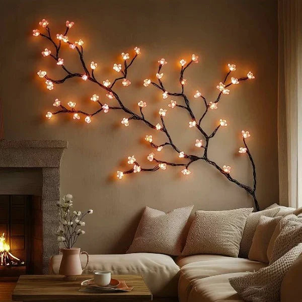 LED cherry blossom vine wall art with warm glowing blossoms along a sweeping branch