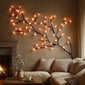 LED cherry blossom vine wall art with warm glowing blossoms along a sweeping branch