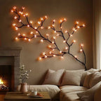 LED cherry blossom vine wall art with warm glowing blossoms along a sweeping branch