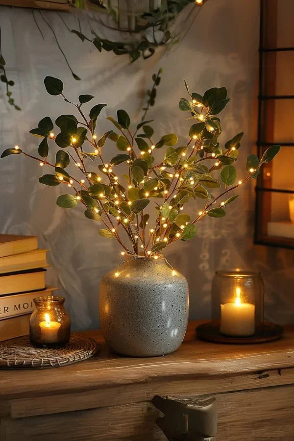 Olive LED branch centerpiece with green leaves, warm white lights, in speckled vase