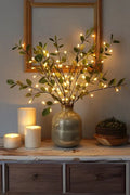 Olive LED branch centerpiece with warm white leaf lights in gray speckled vase