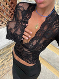 Black lace deep V crop top close-up, long sleeves and scalloped trim