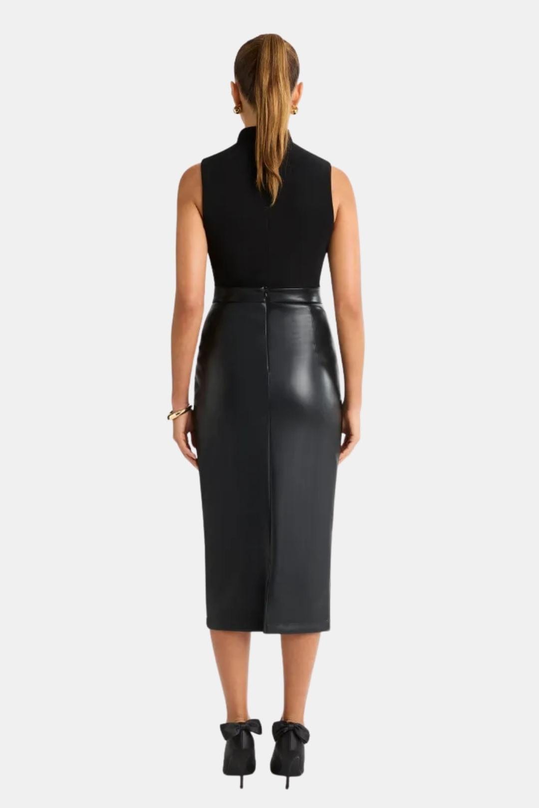 Black faux leather midi skirt with front center split and fitted waistband