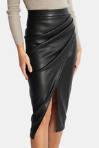 Black faux leather midi skirt with pleated front and diagonal wrap-look split