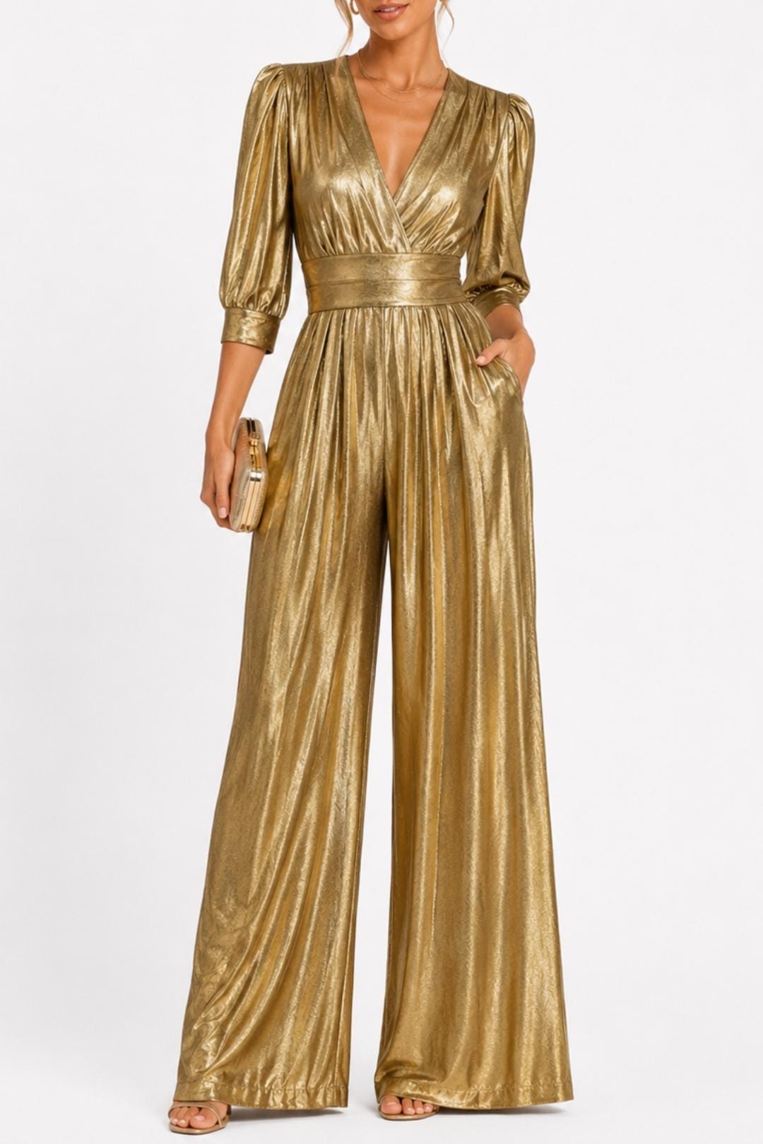 Gold V-neck jumpsuit with gathered waist, long puff sleeves, and flowing wide legs