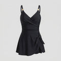 Black one-piece swimdress with surplice bust, ruched tummy control, tie-front skirt, straps