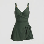Dark green one-piece swimdress with surplice bust, ruched tummy control, tie-front skirt, straps