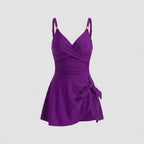 Purple one-piece swimdress with surplice bust, ruched tummy control, tie-front skirt, straps