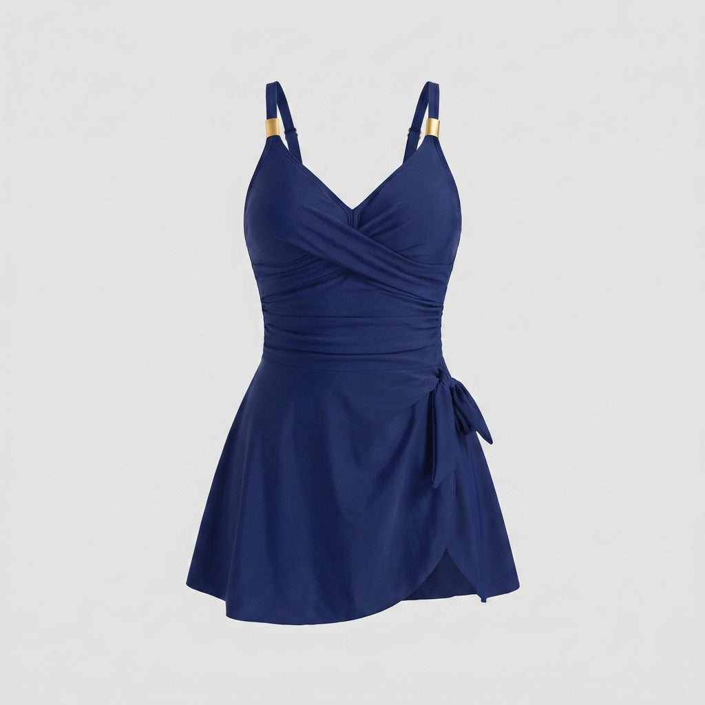 Navy blue one-piece swimdress with surplice bust, ruched tummy control, tie-front skirt, straps