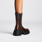 Brown tall boots with black elastic side panels and chunky platform lug sole