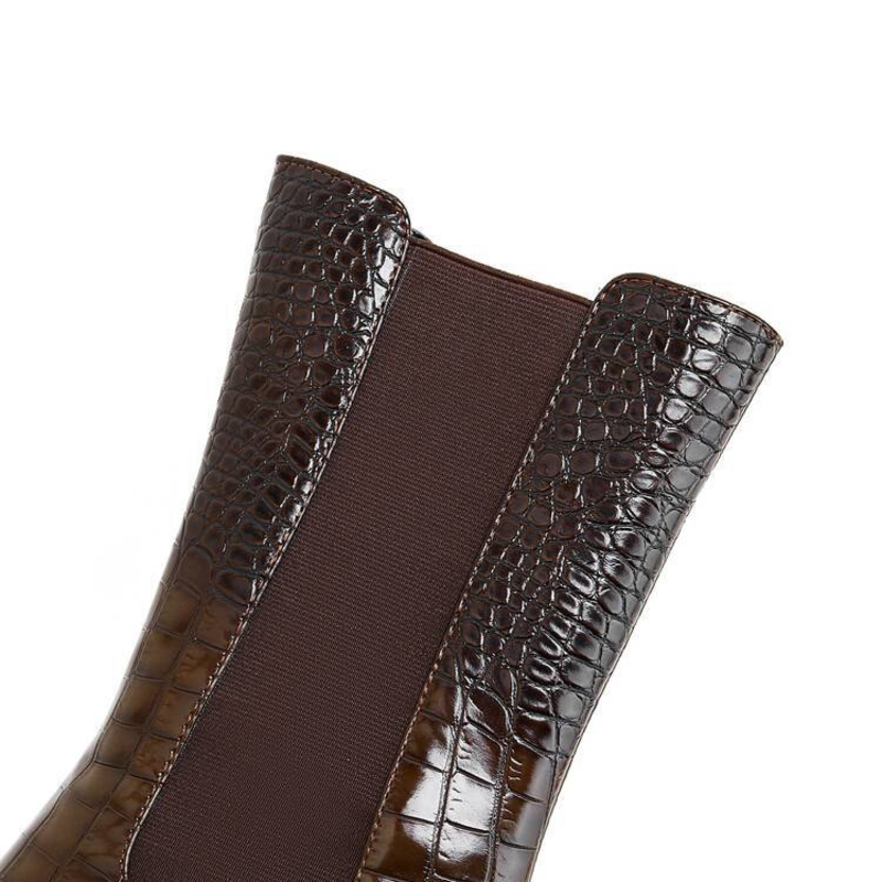 Brown chelsea boots with elastic side panels and textured leather-look finish