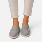Women's gray suede slip-on loafers with strap detail and light rubber sole