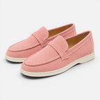 Women's pink suede slip-on loafers with stitched moc toe and low flat sole
