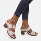 Beige women’s leather block heel sandals with open toe and ankle bead bracelet