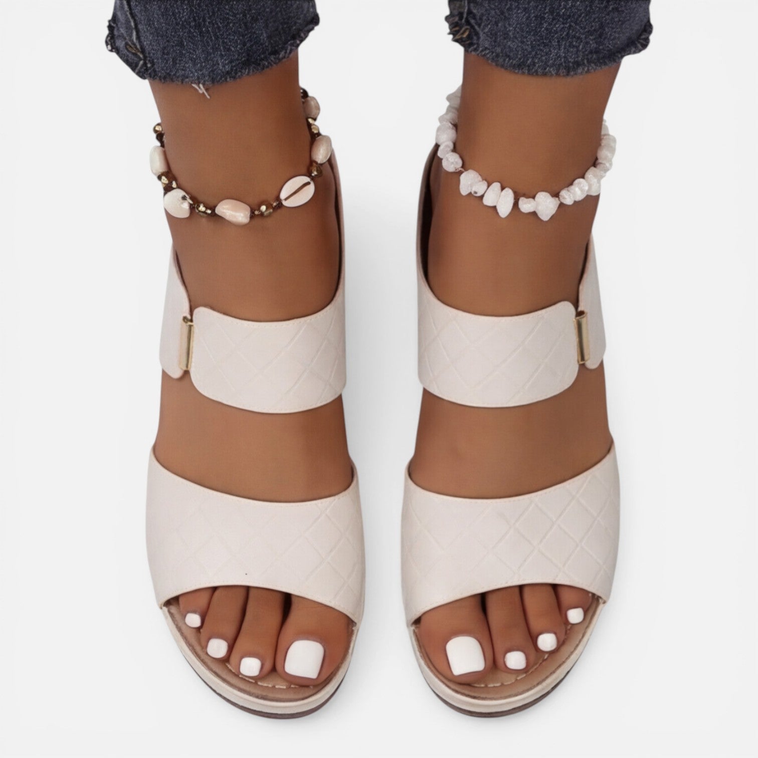 Beige leather block heel sandals with open toe, ankle bead bracelet, and wide strap