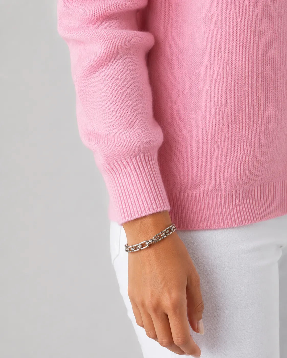 Pink knit button-up cardigan cuff with ribbed trim and sleeve knit texture