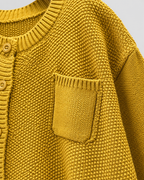 Yellow knit cardigan with front pocket and ribbed knit texture