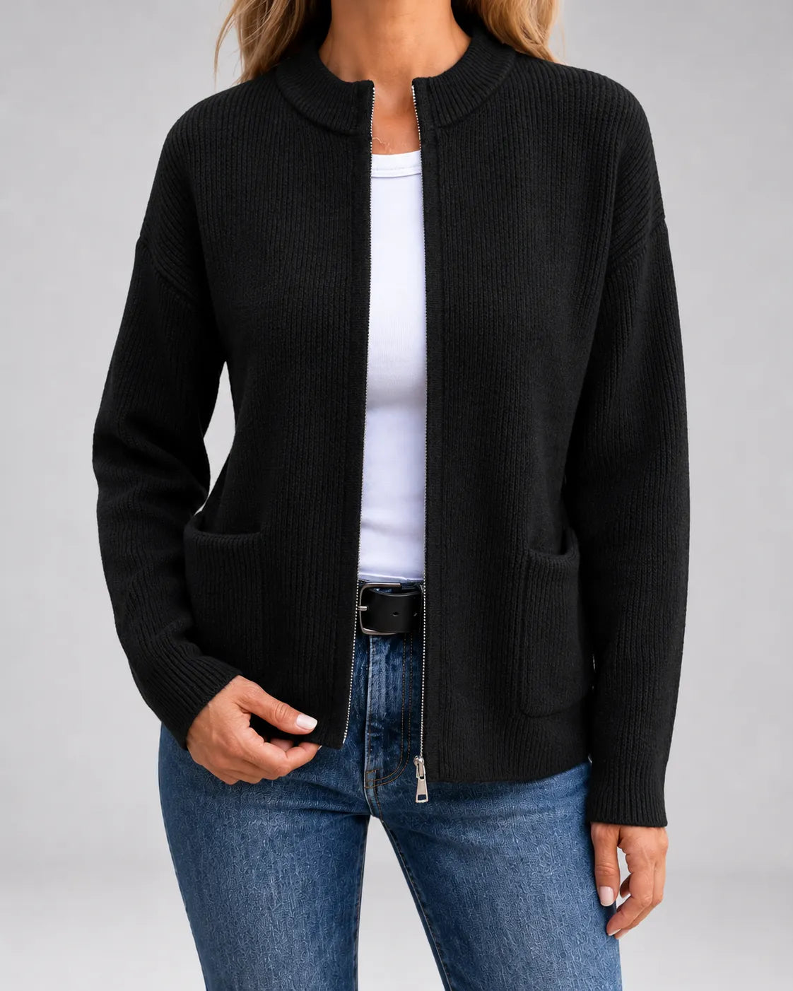 Black open-front knit cardigan with long sleeves, patch pockets, and zipper front