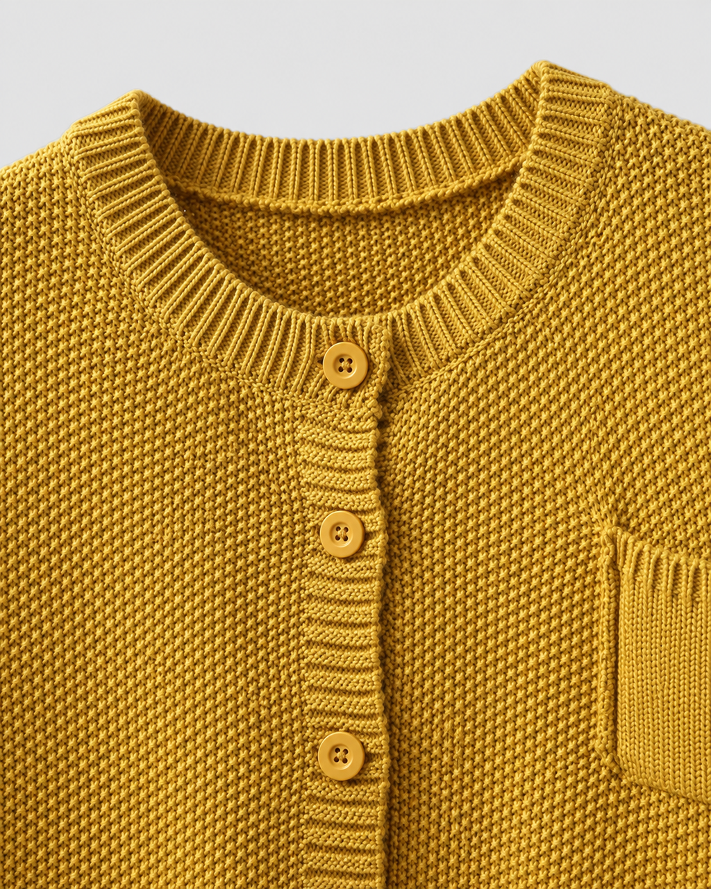 Yellow knit cardigan neckline with ribbed trim and gold button placket