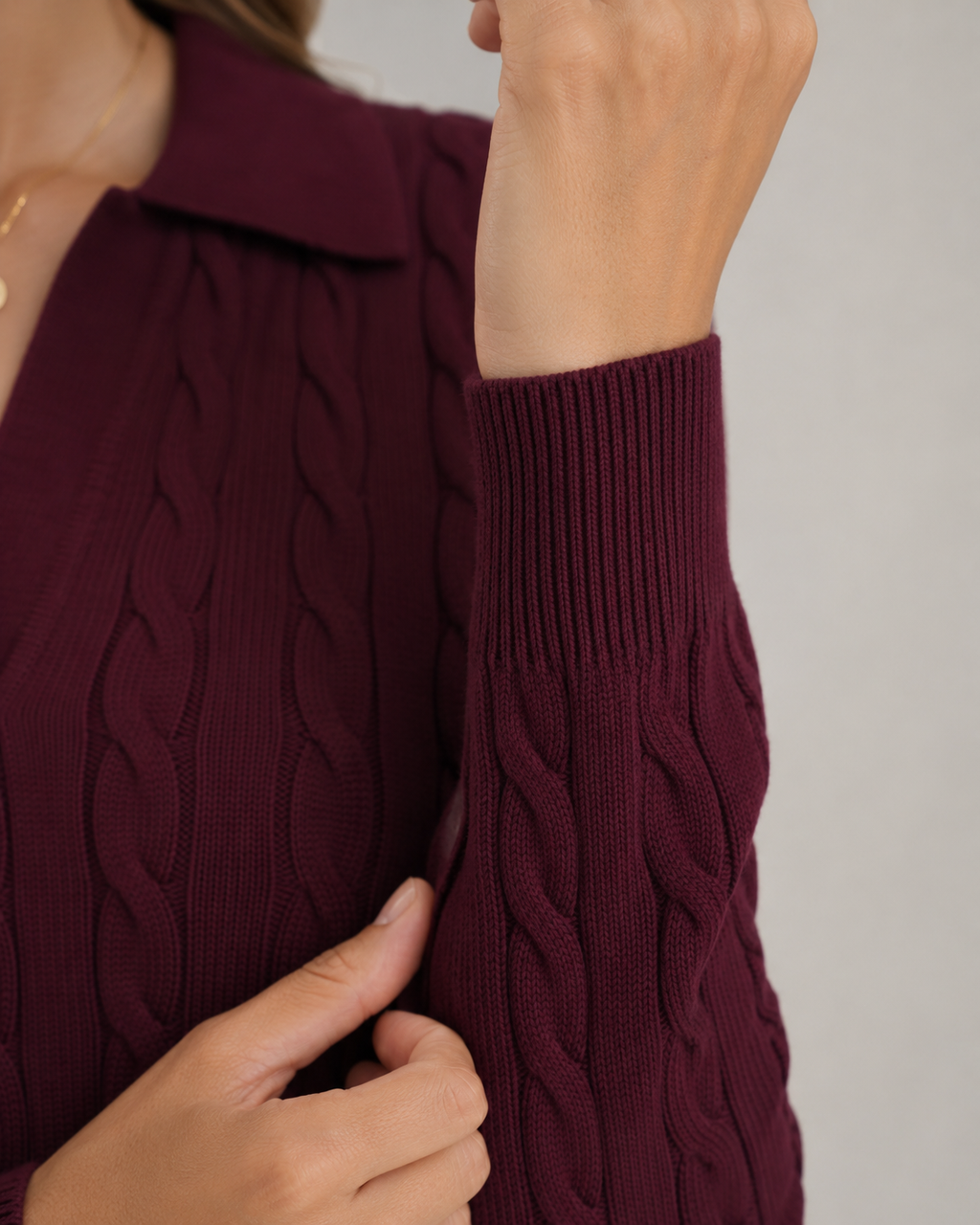 Burgundy cable knit sweater sleeve cuff with ribbed knit hem detail